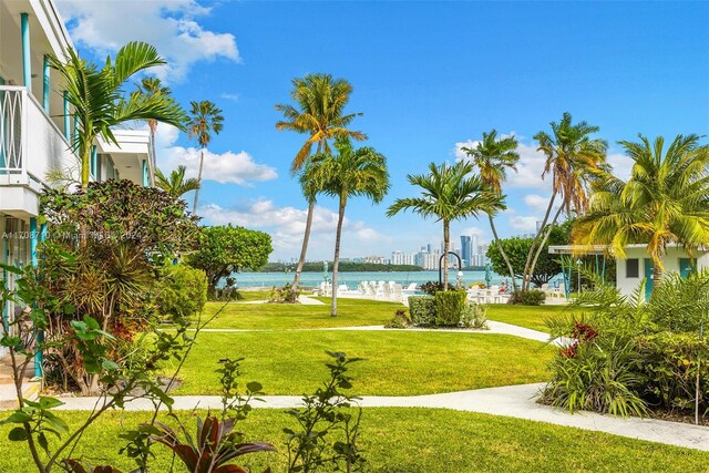 1155 103rd St Unit 7A, Bay Harbor Islands, FL 33154 - view of community with a water view and a lawn