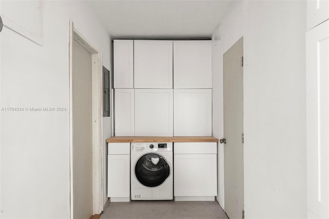 washroom with washer / clothes dryer and cabinets