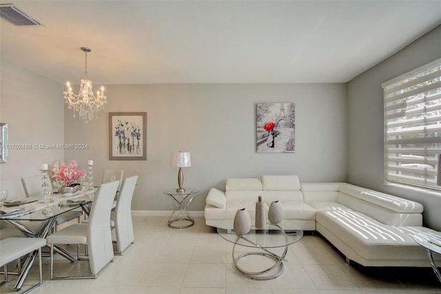 living room with light tile patterned flooring and a notable chandelier