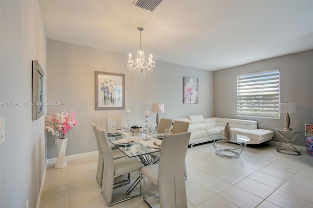 tiled dining area with a chandelier