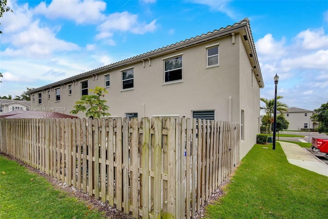 view of side of home featuring a yard