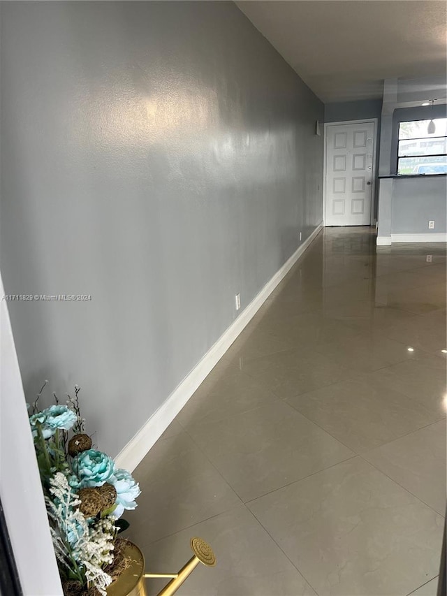 hallway with tile patterned floors