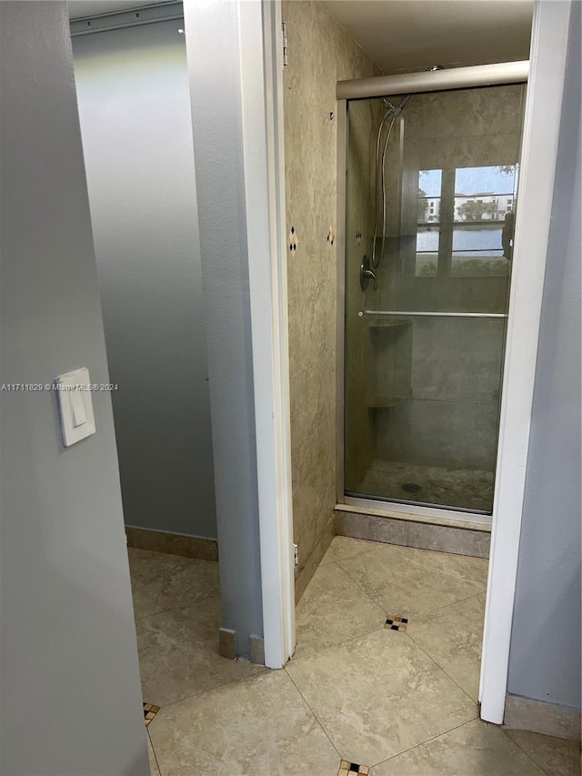 bathroom with tile patterned flooring and an enclosed shower