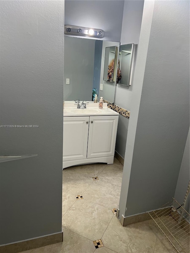 bathroom with tile patterned flooring and vanity