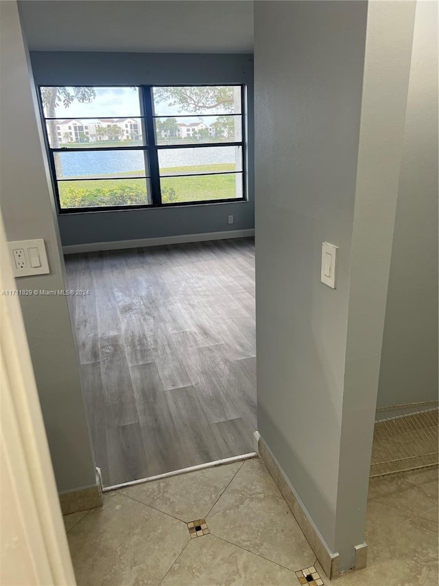 hallway featuring plenty of natural light and light wood-type flooring