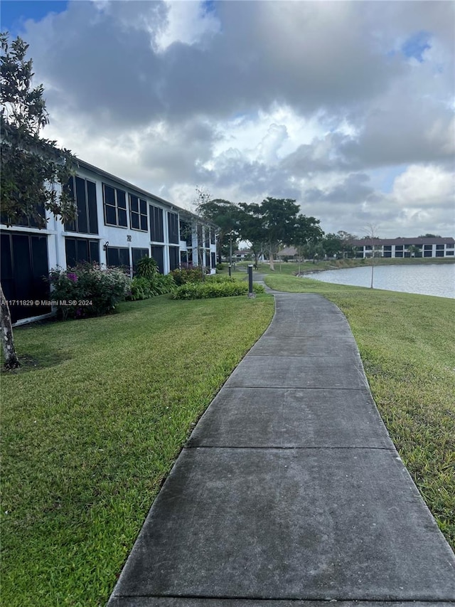 surrounding community featuring a yard and a water view