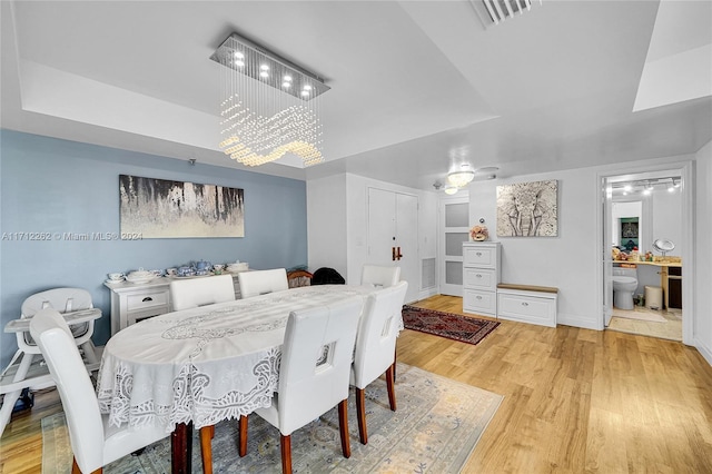 11113 Biscayne Blvd Unit 255, Miami, FL 33181 - dining space with a tray ceiling and light wood finished floors