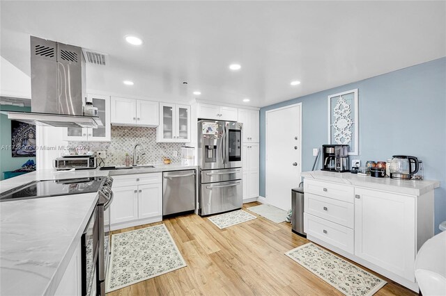 11113 Biscayne Blvd Unit 255, Miami, FL 33181 - kitchen featuring stainless steel appliances, exhaust hood, light wood-type flooring, white cabinets, and glass insert cabinets