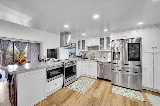 11113 Biscayne Blvd Unit 255, Miami, FL 33181 - kitchen with appliances with stainless steel finishes, island exhaust hood, a peninsula, light countertops, and glass insert cabinets