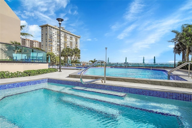 view of swimming pool featuring a water view