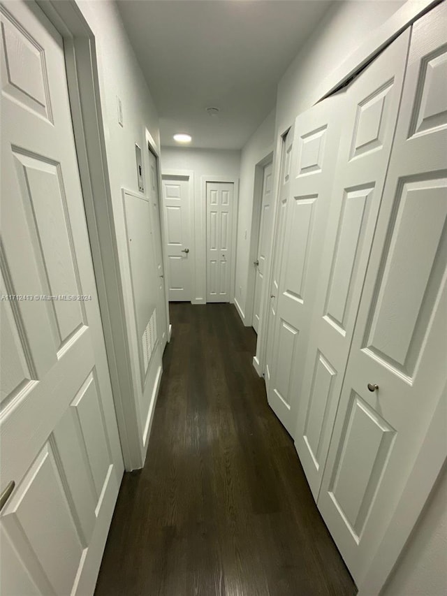 corridor with dark wood-type flooring