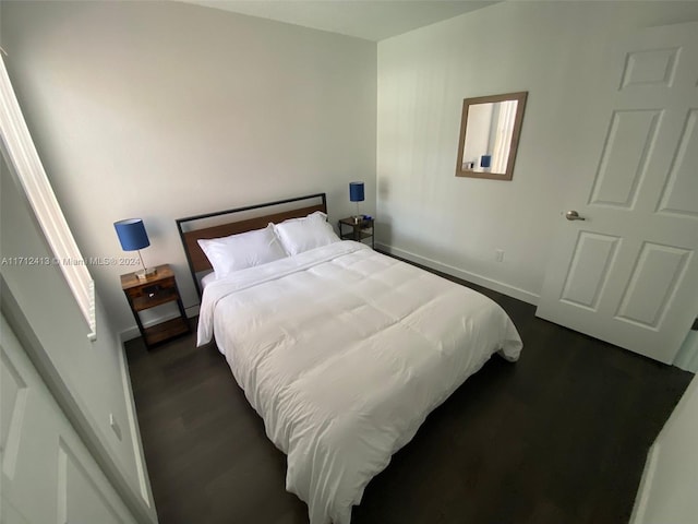 bedroom featuring dark wood-type flooring