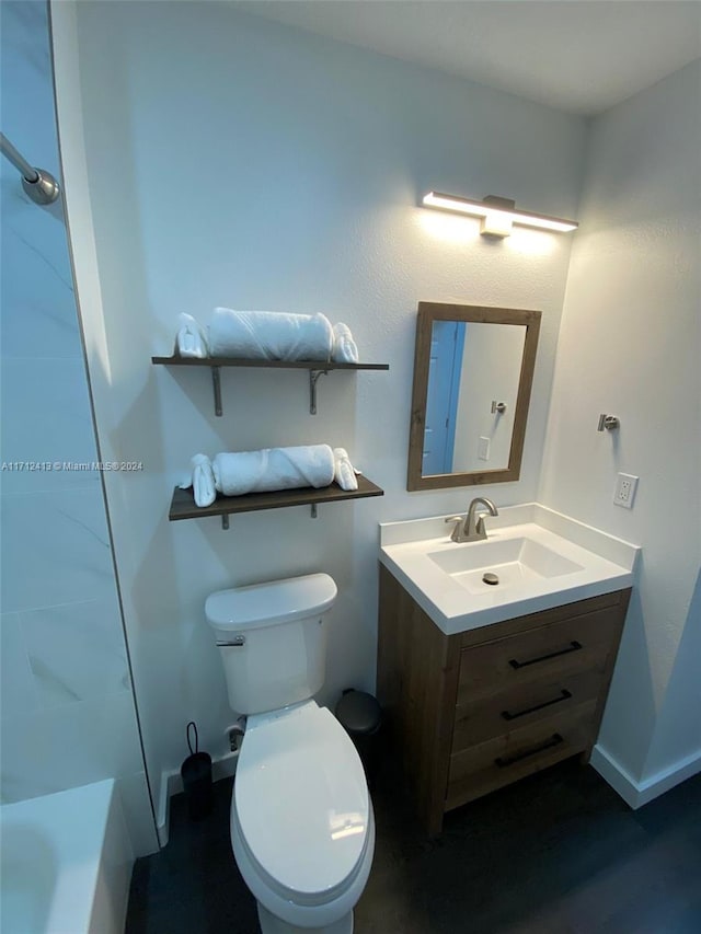 bathroom featuring a tub to relax in, vanity, and toilet