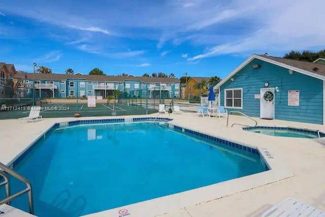 view of pool featuring a patio area and a community hot tub