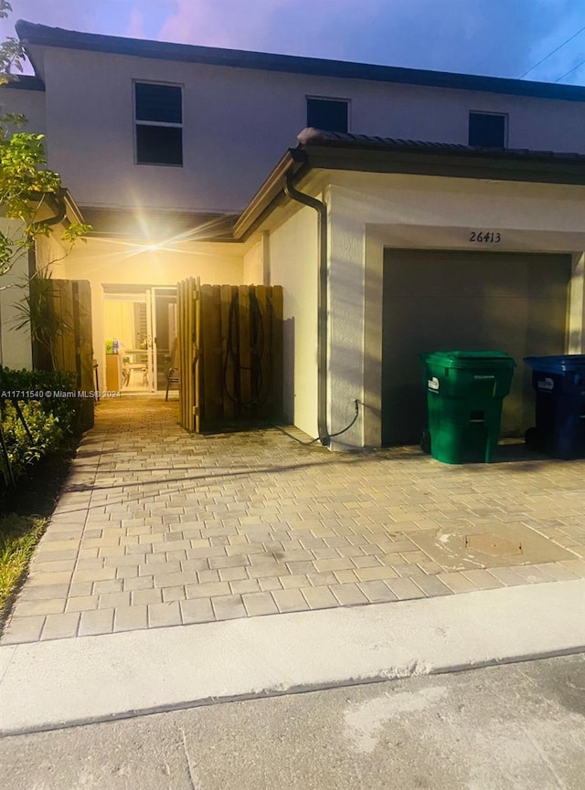 exterior entry at dusk with a garage