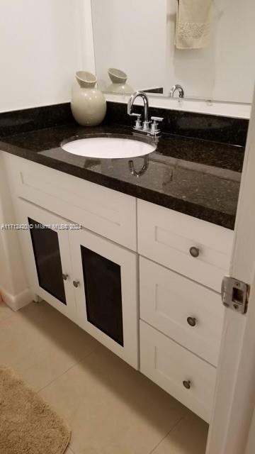 bathroom with tile patterned flooring and vanity