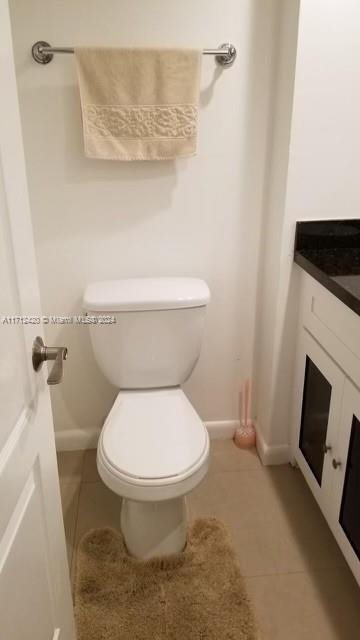 bathroom with tile patterned flooring, vanity, and toilet