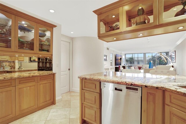 kitchen with stainless steel dishwasher, light stone countertops, light tile patterned floors, and crown molding