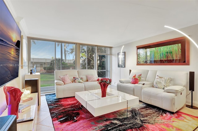 living room with crown molding, light tile patterned floors, and a healthy amount of sunlight