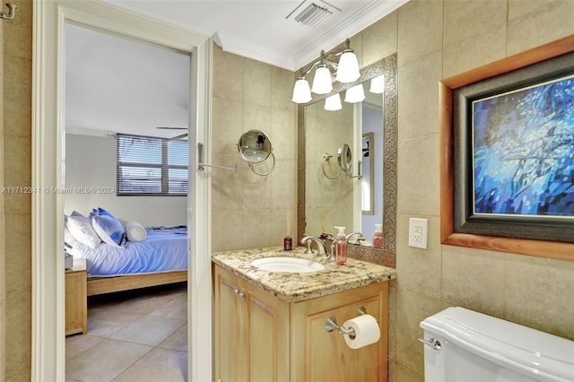 bathroom featuring tile patterned flooring, tile walls, and ornamental molding