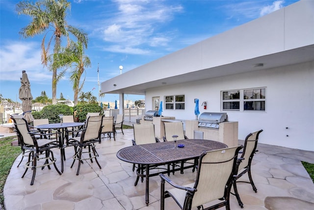 view of patio with an outdoor kitchen and a grill