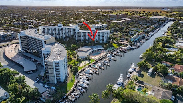 birds eye view of property with a view of city and a water view