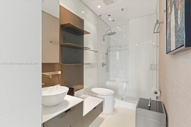 bathroom with vanity, a shower with shower door, and toilet