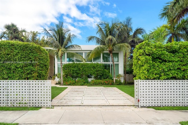 obstructed view of property featuring a front yard