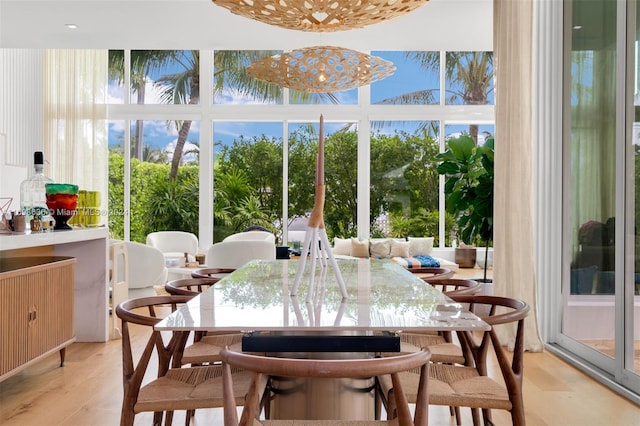 sunroom / solarium with a healthy amount of sunlight and a chandelier