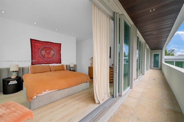 unfurnished bedroom featuring light wood-type flooring and wooden ceiling