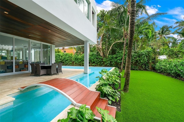 view of pool with a yard and a patio area