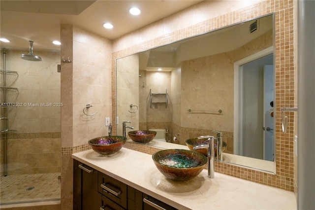 bathroom featuring vanity, tile walls, and an enclosed shower