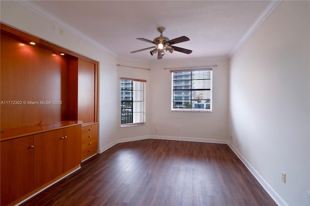 spare room with ornamental molding, dark wood-type flooring, and ceiling fan