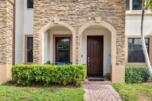 3217 SE 4th Ct Unit 3217, Homestead, FL 33033 - doorway to property with stucco siding and stone siding