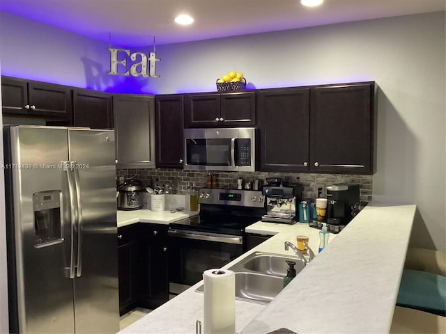 kitchen featuring decorative backsplash, appliances with stainless steel finishes, decorative light fixtures, and sink