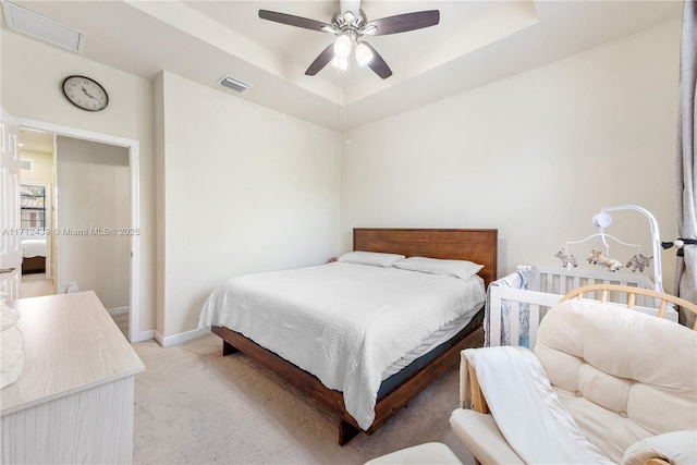 3217 SE 4th Ct Unit 3217, Homestead, FL 33033 - bedroom with a tray ceiling, a ceiling fan, visible vents, light carpet, and baseboards