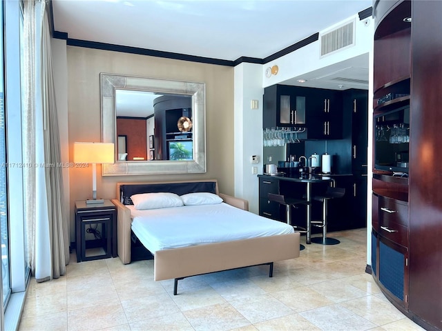 bedroom featuring crown molding and indoor bar