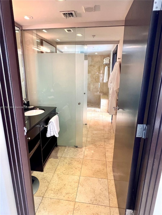 bathroom with tile patterned floors and vanity