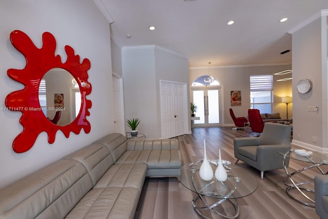 living room with french doors, hardwood / wood-style flooring, and crown molding