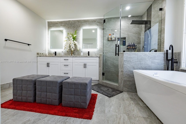 bathroom featuring vanity, tile walls, and independent shower and bath