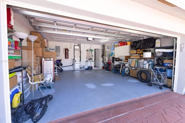 garage featuring electric panel and a garage door opener