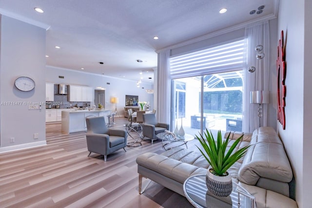 living room featuring light hardwood / wood-style flooring and ornamental molding