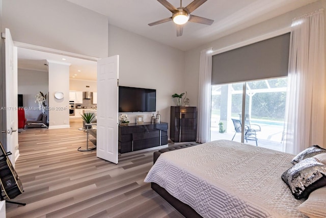 bedroom with hardwood / wood-style floors, ceiling fan, and access to exterior