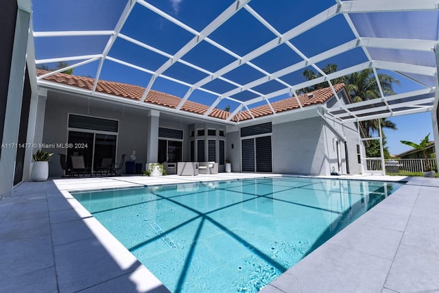 view of swimming pool with a patio and glass enclosure