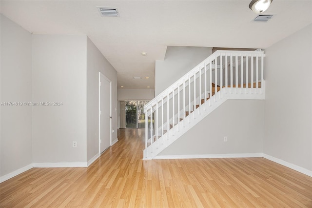 stairs with hardwood / wood-style flooring