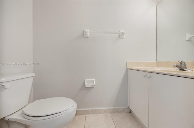 bathroom featuring tile patterned flooring, vanity, and toilet