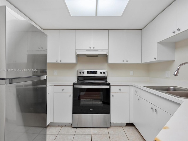 kitchen with sink, white cabinets, light tile patterned flooring, and appliances with stainless steel finishes