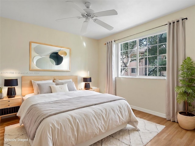 bedroom with ceiling fan and light hardwood / wood-style flooring