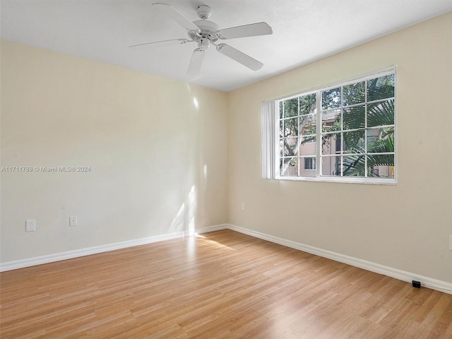 spare room with light wood-type flooring and ceiling fan