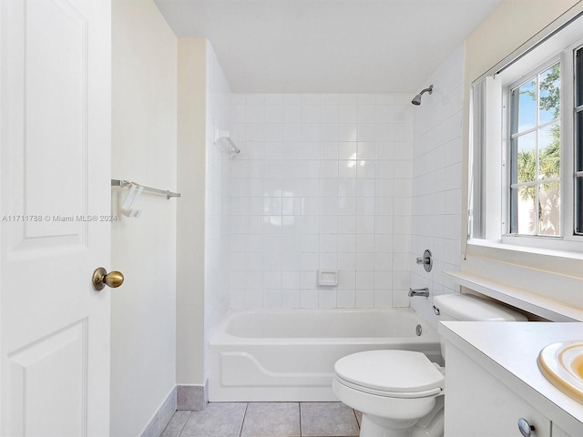 full bathroom featuring tile patterned flooring, vanity, toilet, and tiled shower / bath